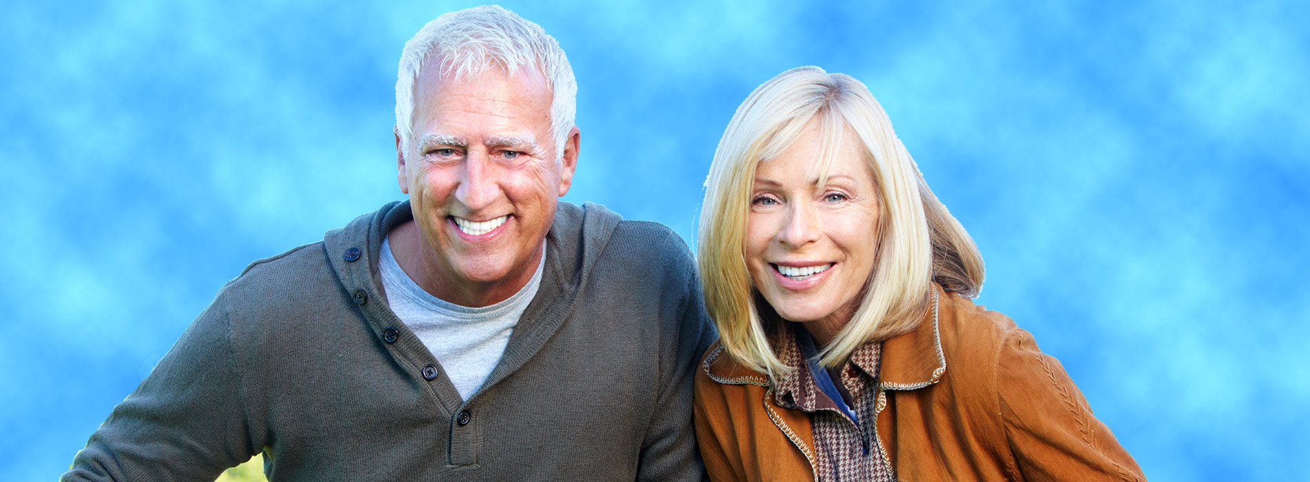 The image shows a man and a woman posing together outdoors  the man is on the left and the woman on the right, both are smiling, and they appear to be enjoying their time together.